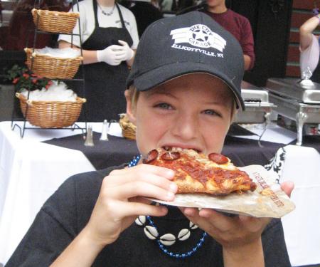 Girl tasting pizza at a Taste of Ellicottville